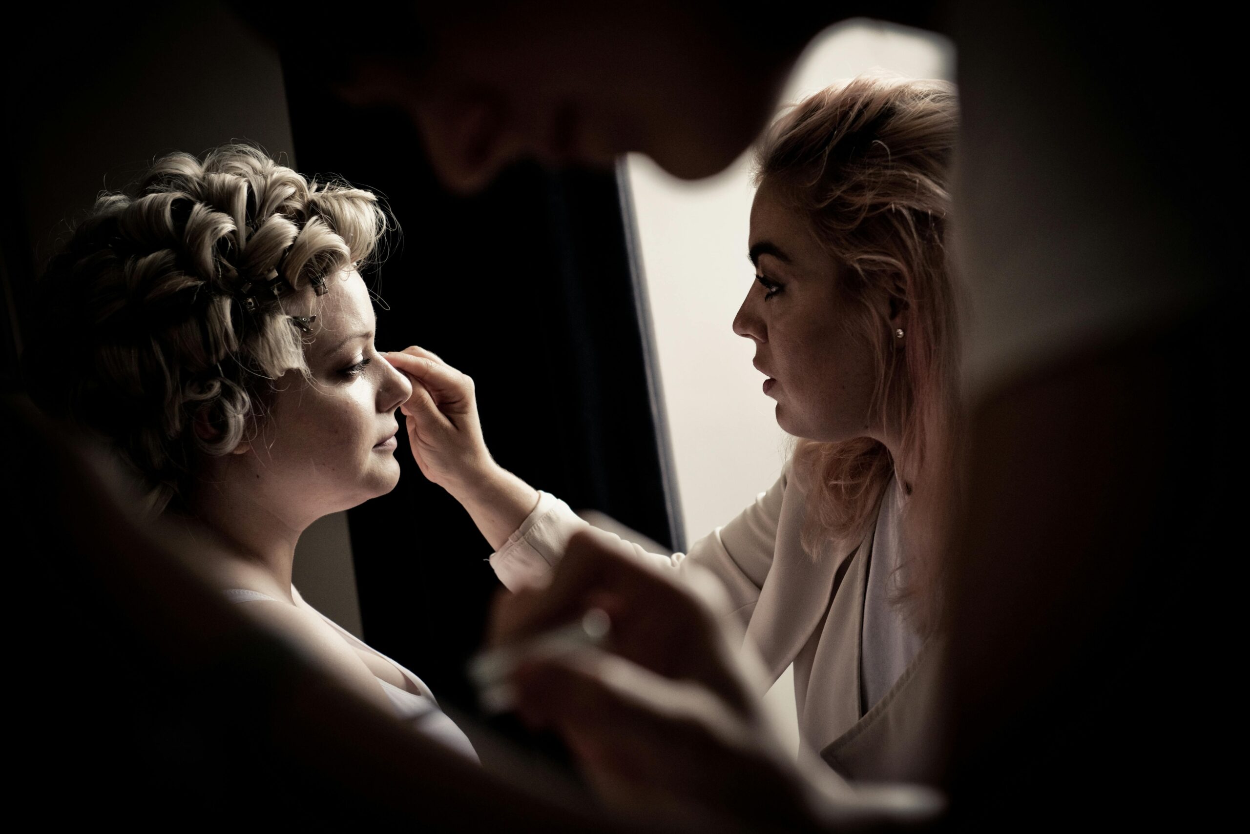 A makeup artist working on a bride