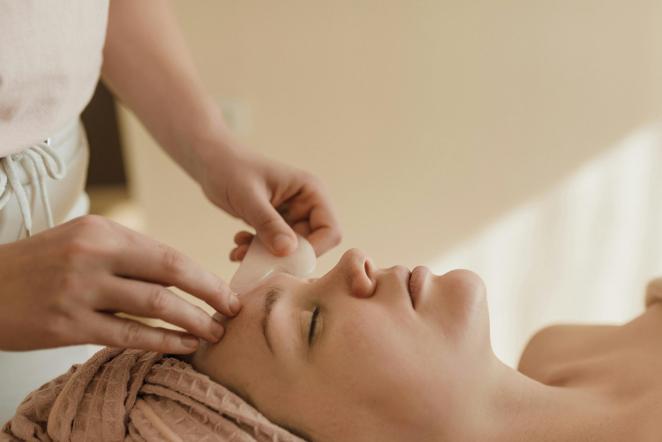 A woman receiving a facial massage