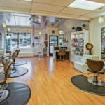 Spacious hair salon in Del Mar, California featuring contemporary design and ample seating.