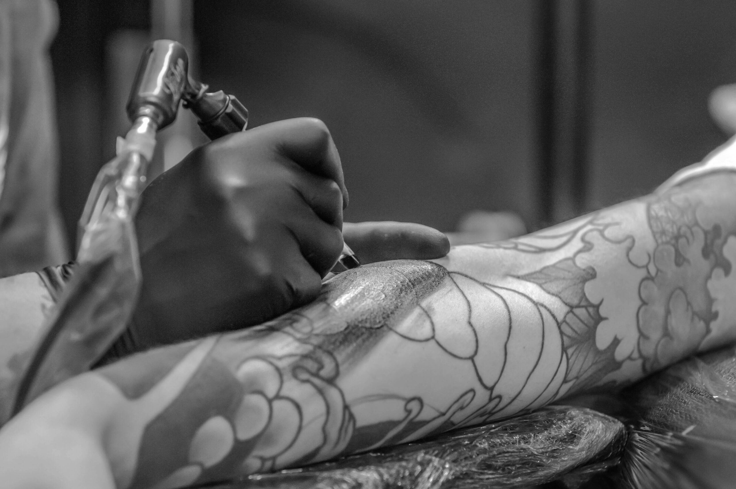A tattoo being applied to an arm